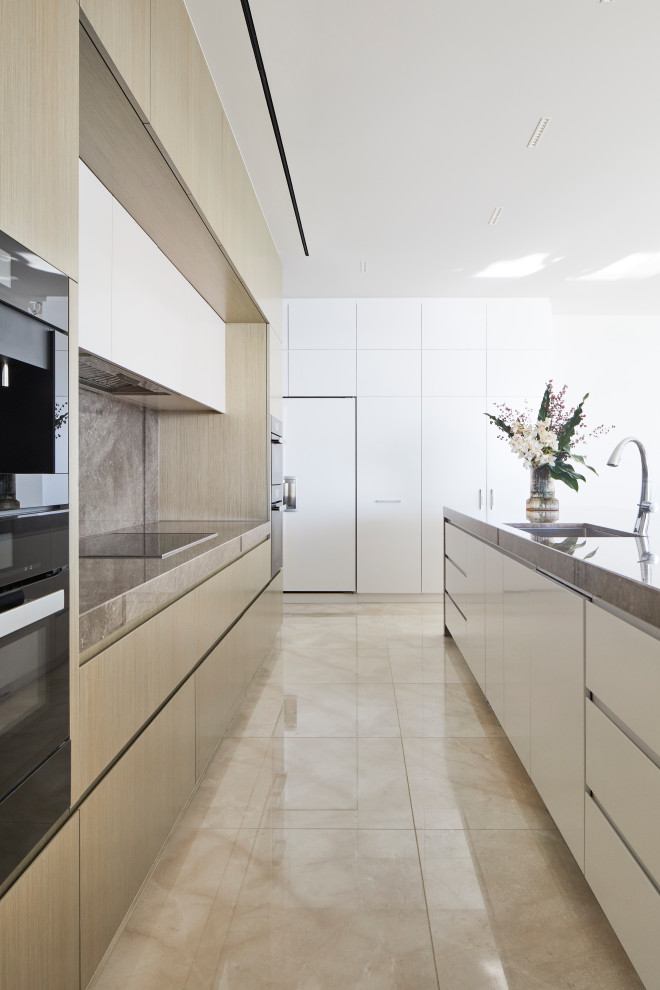 Design ideas for a large contemporary galley kitchen pantry in Melbourne with an undermount sink, medium wood cabinets, marble benchtops, marble splashback, black appliances, marble floors, with island and purple benchtop.