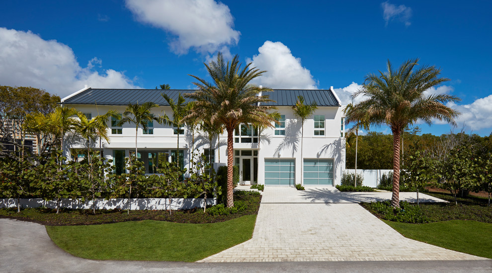 Inspiration for a large contemporary white two-story gable roof remodel in Miami