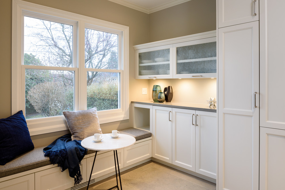 Inspiration for a small transitional u-shaped limestone floor and gray floor enclosed kitchen remodel in Seattle with an undermount sink, recessed-panel cabinets, white cabinets, quartz countertops, gray backsplash, ceramic backsplash, stainless steel appliances, no island and gray countertops