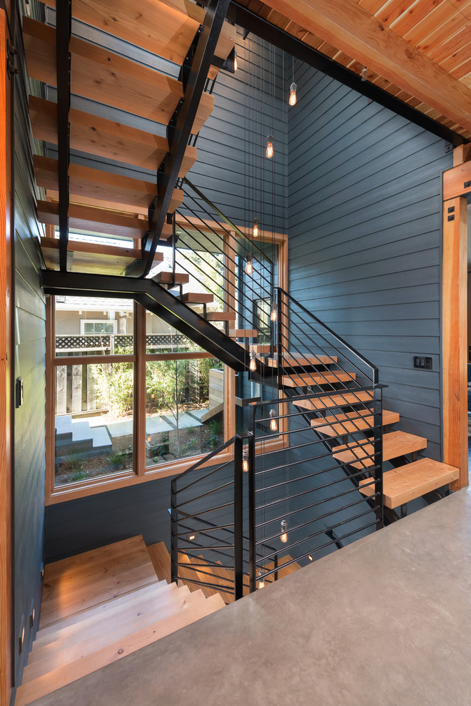 Large country wood u-shaped staircase in San Francisco with open risers.