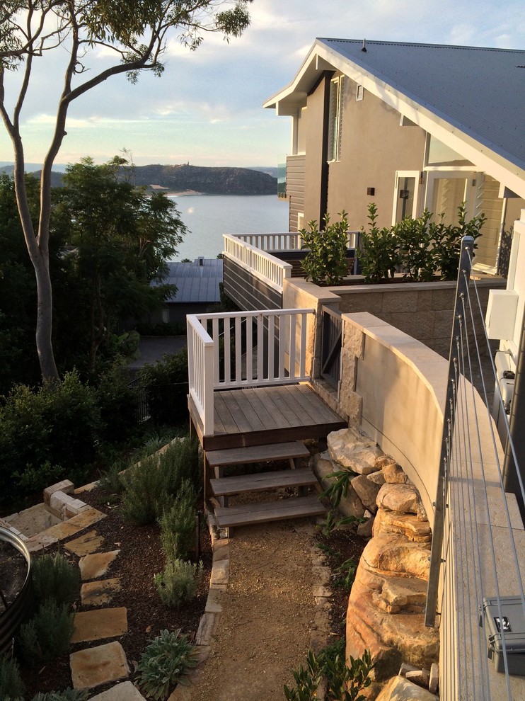 This is an example of a large beach style three-storey brick blue exterior in Sydney.