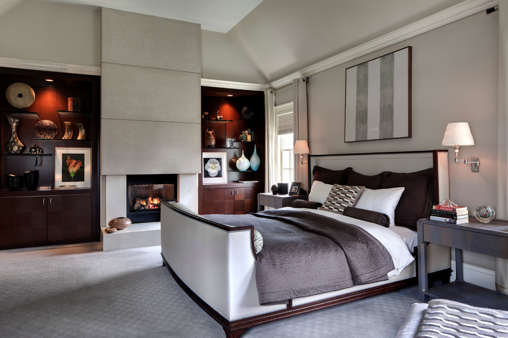 Contemporary master bedroom in New York with beige walls, carpet and a standard fireplace.