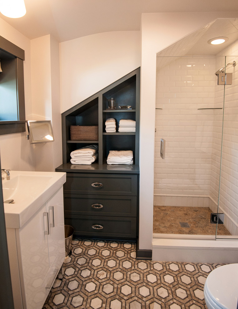 Small modern bathroom in Other with a console sink, furniture-like cabinets, grey cabinets, an alcove shower, a two-piece toilet, brown tile, subway tile, white walls and mosaic tile floors.