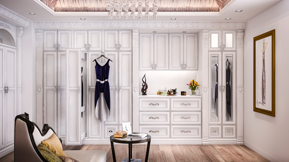 Large traditional women's walk-in wardrobe in Los Angeles with recessed-panel cabinets, white cabinets and medium hardwood floors.
