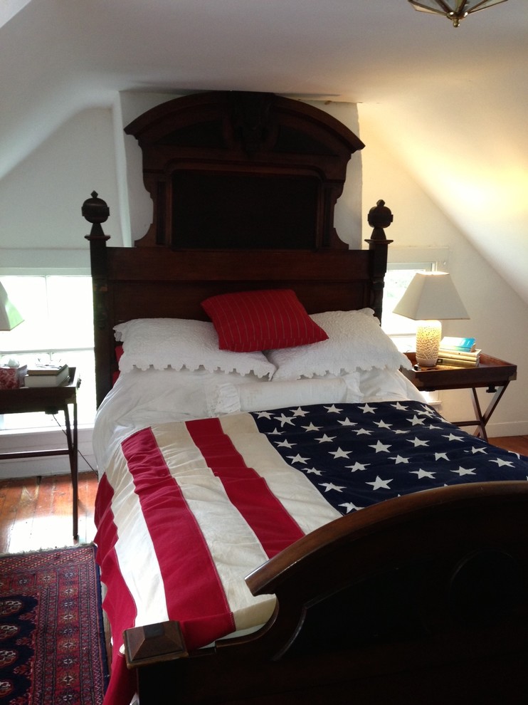 Example of a mid-sized transitional guest medium tone wood floor bedroom design in Baltimore with white walls