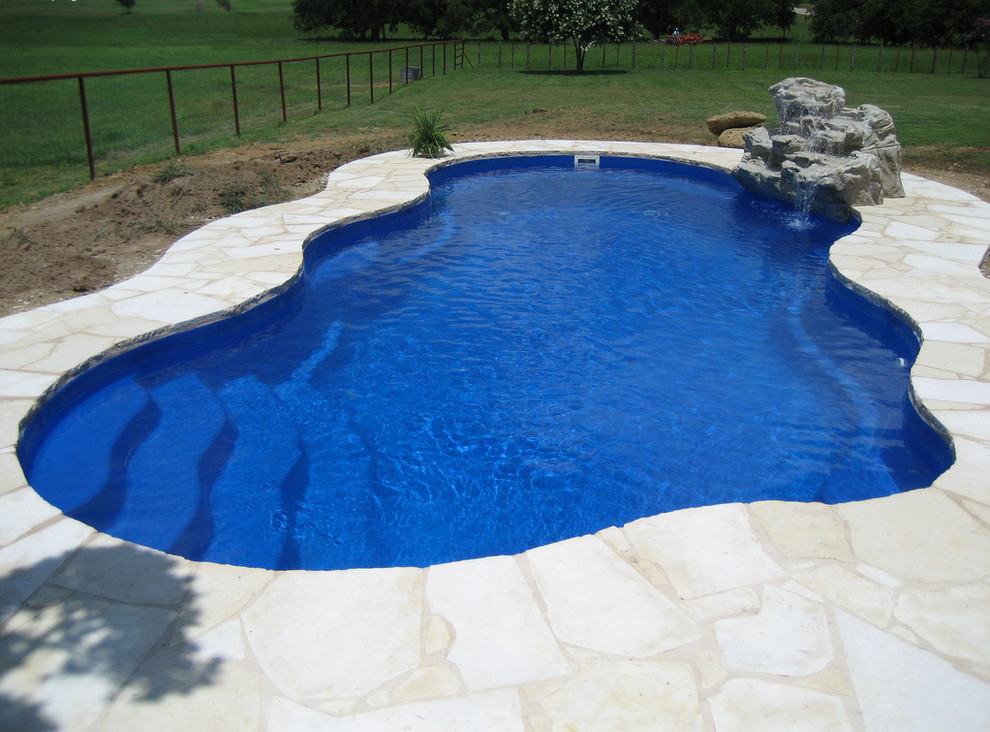 Pool fountain - mid-sized backyard stone and custom-shaped natural pool fountain idea in Cincinnati