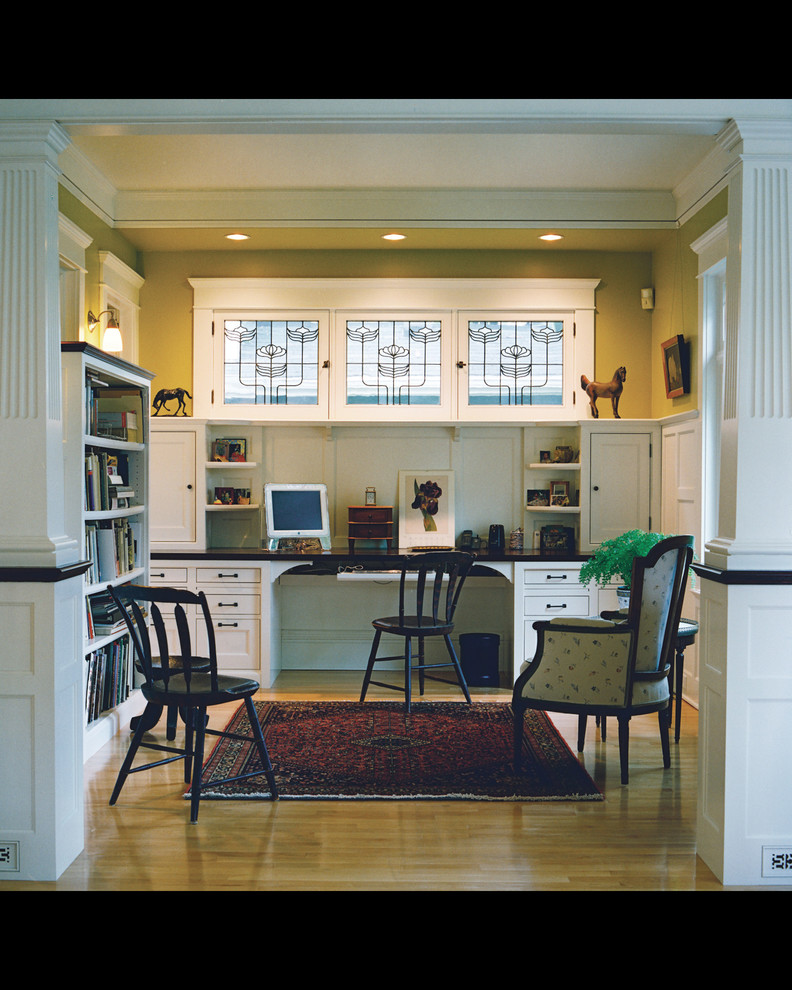 Traditional study room in Minneapolis with yellow walls, medium hardwood floors, no fireplace and a built-in desk.