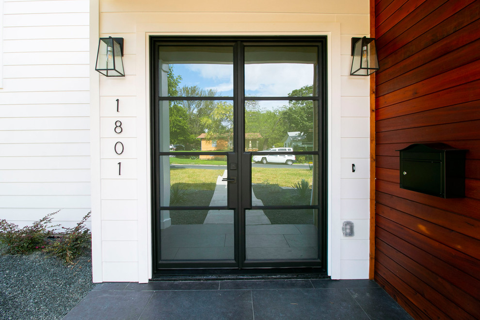 Design ideas for a contemporary front door in Austin with white walls, a double front door and a black front door.