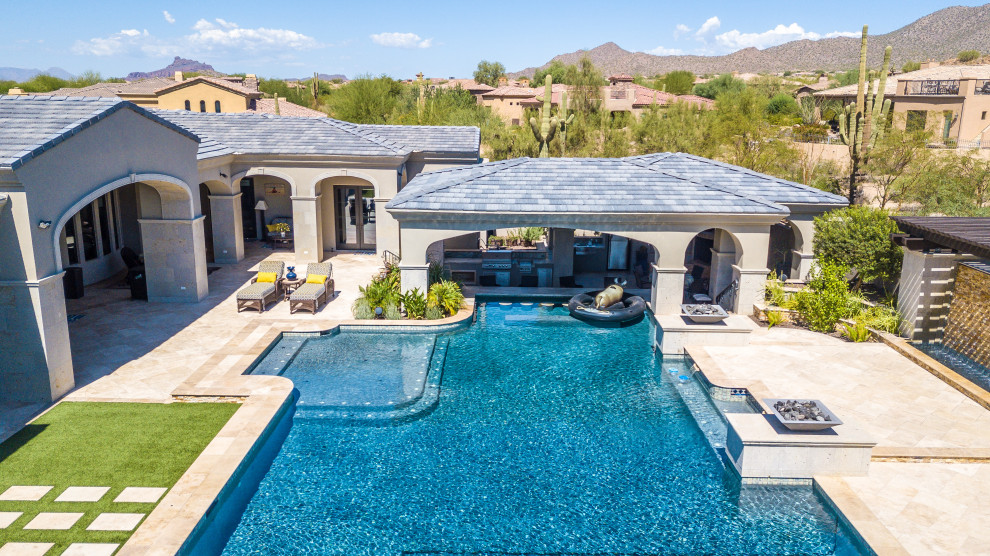 Design ideas for an expansive mediterranean backyard custom-shaped pool in Phoenix.