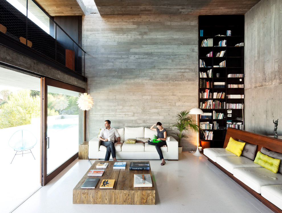 This is an example of a contemporary living room in New York with a library.