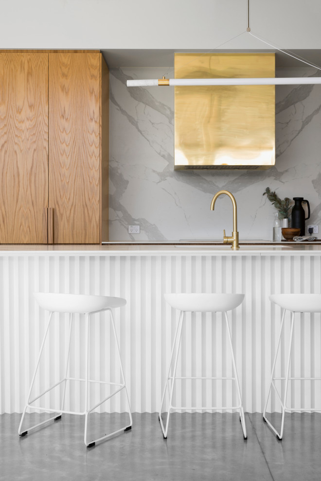 Photo of a scandinavian eat-in kitchen in Brisbane with light wood cabinets, marble benchtops, marble splashback, concrete floors, a peninsula and grey floor.