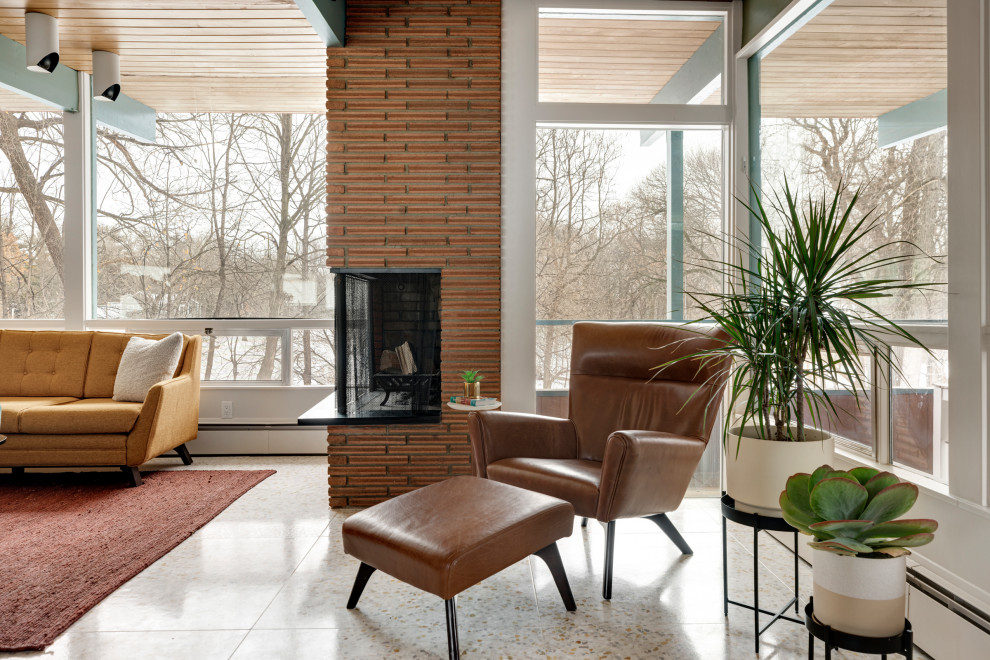 Medium sized midcentury open plan living room in Minneapolis with white walls, a corner fireplace, a brick fireplace surround, white floors, exposed beams and wood walls.