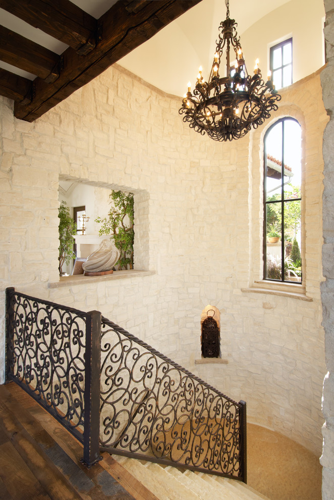 This is an example of a large mediterranean u-shaped staircase in Denver.