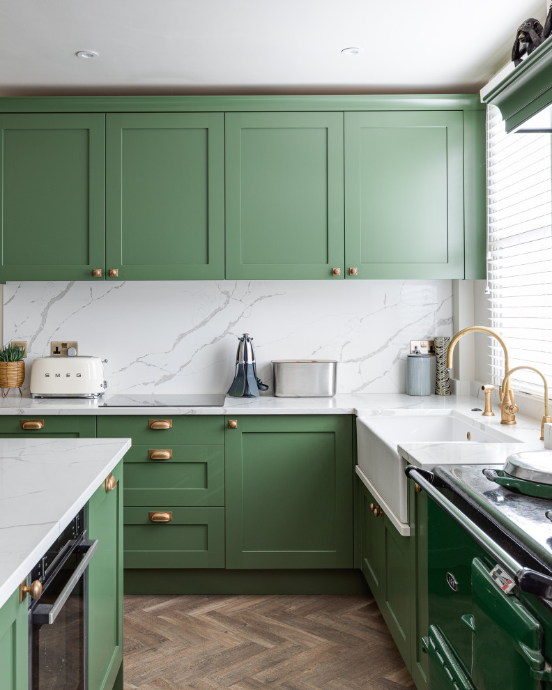 Photo of a large classic u-shaped kitchen/diner in Hertfordshire with shaker cabinets, green cabinets, quartz worktops and an island.