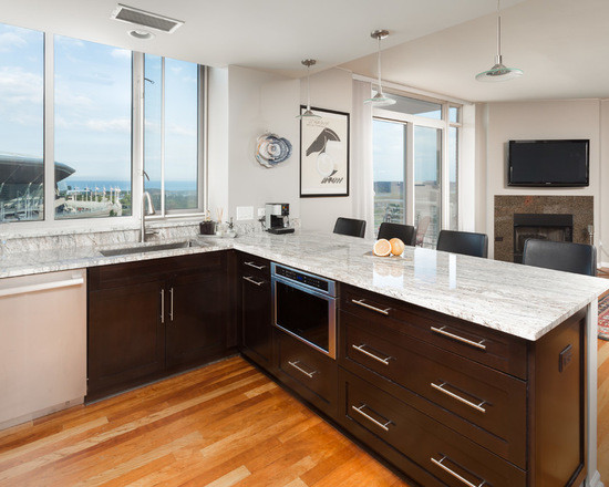 Inspiration for a mid-sized transitional u-shaped medium tone wood floor open concept kitchen remodel in Chicago with an undermount sink, shaker cabinets, dark wood cabinets, marble countertops, white backsplash, subway tile backsplash, stainless steel appliances and a peninsula