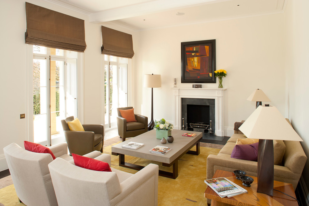 This is an example of a mid-sized contemporary living room in London with white walls and a standard fireplace.