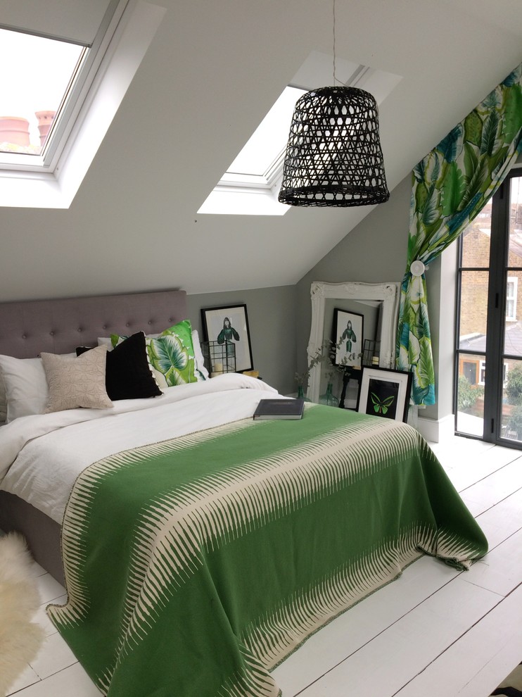 Large tropical master bedroom in Surrey with grey walls, painted wood floors and white floor.