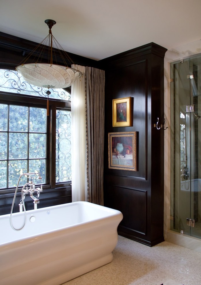 Photo of a traditional master bathroom in Los Angeles with a freestanding tub, black walls and mosaic tile floors.