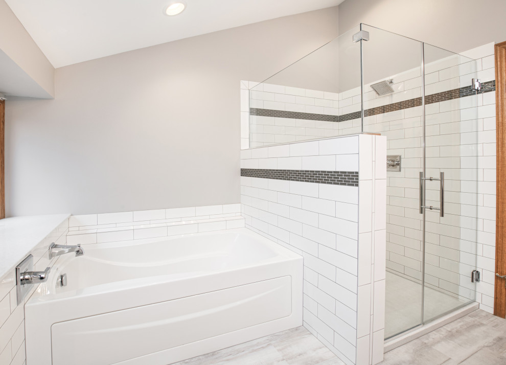 Photo of a large transitional master bathroom in Milwaukee with flat-panel cabinets, dark wood cabinets, an alcove tub, an alcove shower, a two-piece toilet, white tile, ceramic tile, grey walls, laminate floors, an integrated sink, onyx benchtops, grey floor, a shower curtain, white benchtops, a niche, a double vanity, a built-in vanity and vaulted.