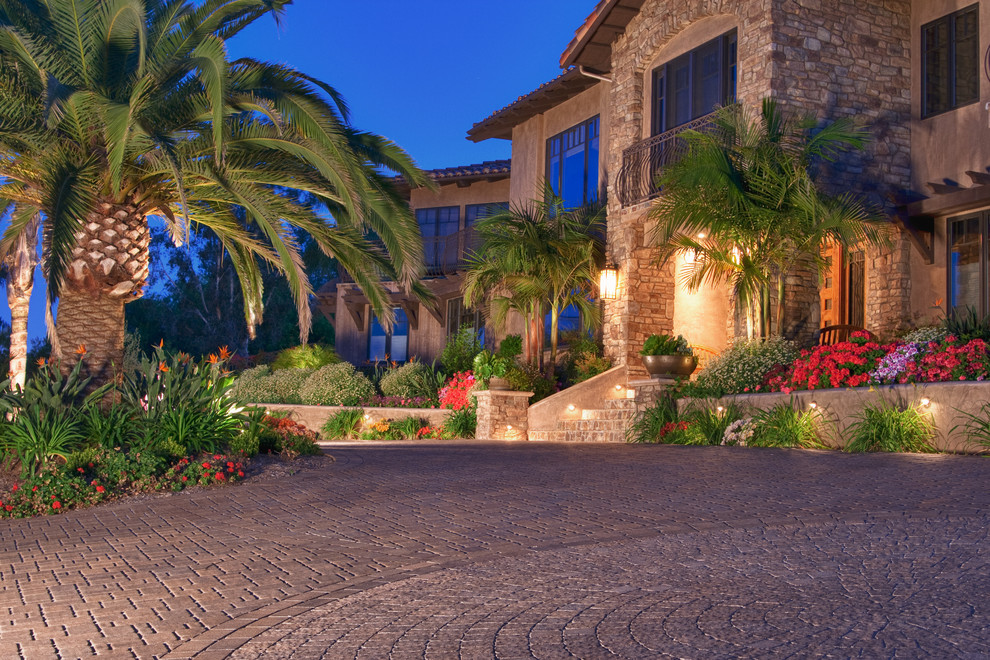 Inspiration for an expansive mediterranean front yard driveway in San Diego with concrete pavers.