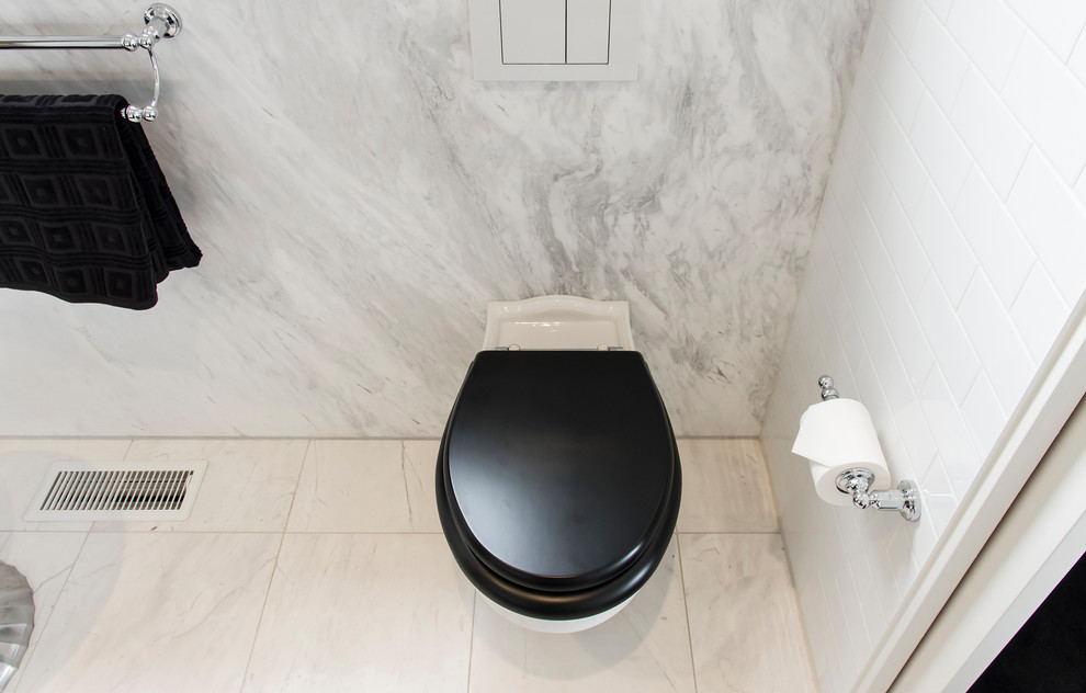 This is an example of a mid-sized traditional master bathroom in Sydney with furniture-like cabinets, black cabinets, an open shower, a wall-mount toilet, white tile, porcelain tile, white walls, marble floors, an undermount sink and marble benchtops.