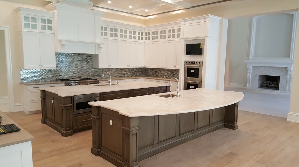Inspiration for a transitional kitchen remodel in Miami with shaker cabinets, white cabinets and two islands