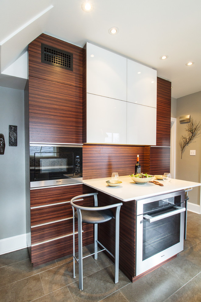 Small contemporary galley separate kitchen in Other with an undermount sink, flat-panel cabinets, medium wood cabinets, quartz benchtops, metallic splashback, mosaic tile splashback, stainless steel appliances, porcelain floors and a peninsula.