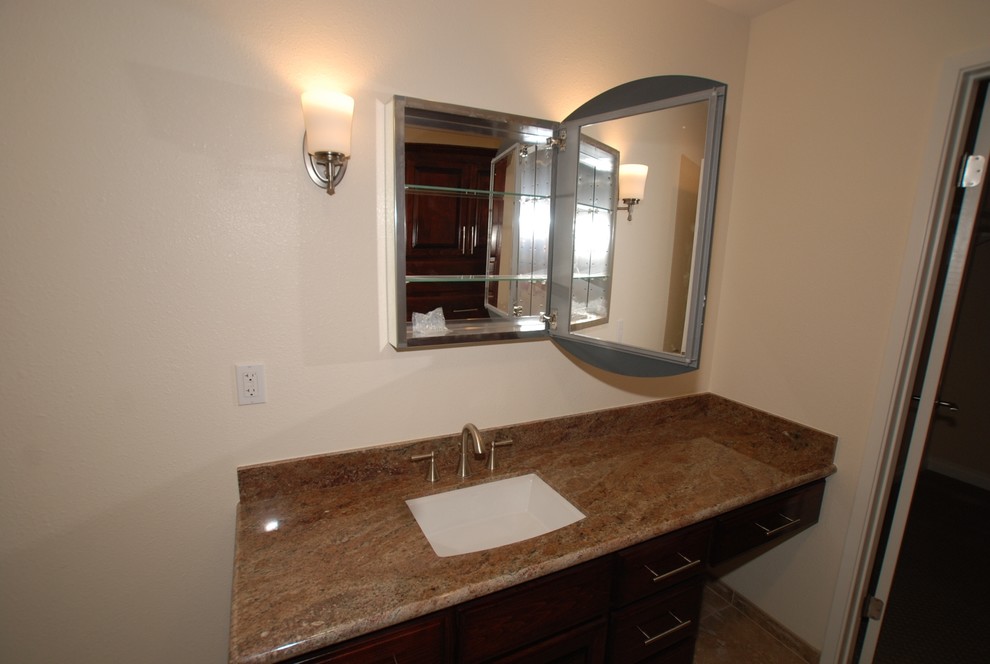 Large traditional master bathroom in Orange County with an undermount sink, raised-panel cabinets, dark wood cabinets, granite benchtops, a corner shower, a two-piece toilet, beige tile, porcelain tile and white walls.