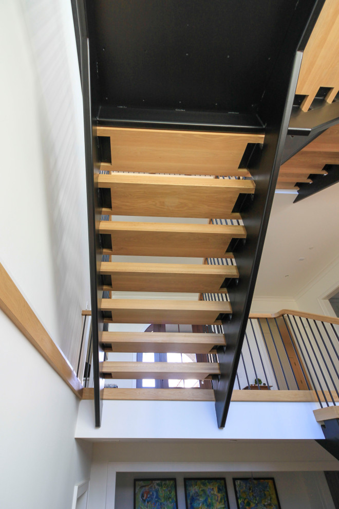 Inspiration pour un très grand escalier flottant minimaliste avec des marches en bois, un garde-corps en matériaux mixtes et du lambris de bois.