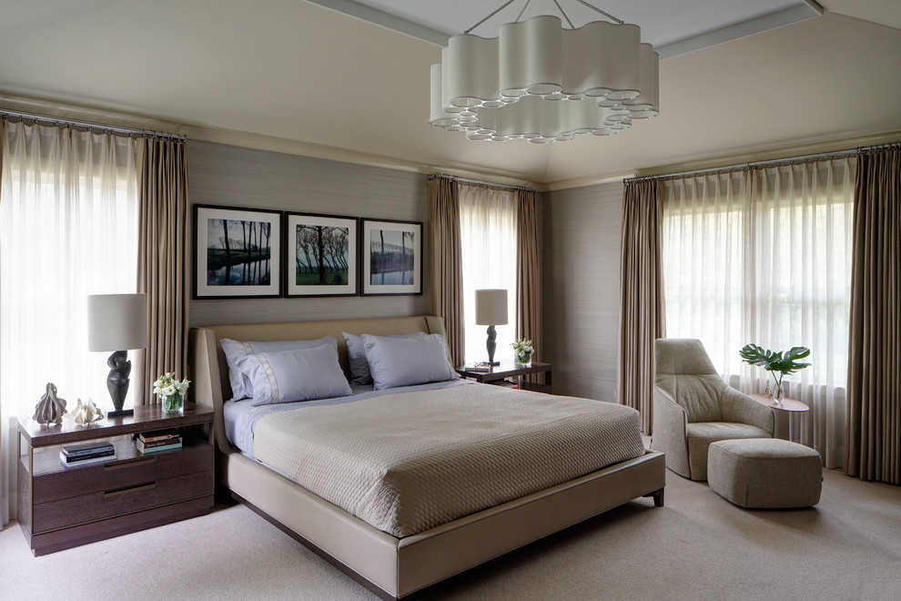 Large contemporary master bedroom in Chicago with beige walls, carpet and beige floor.