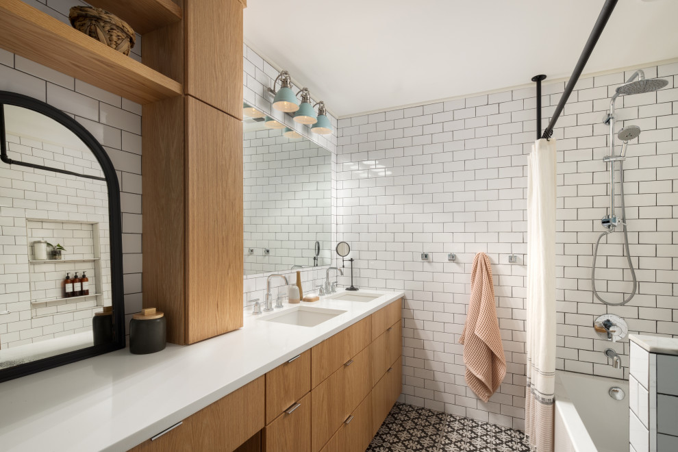 Inspiration for a mid-sized transitional master white tile and subway tile porcelain tile, black floor and double-sink alcove bathtub remodel in DC Metro with flat-panel cabinets, medium tone wood cabinets, a two-piece toilet, blue walls, an undermount sink, quartzite countertops, white countertops, a niche and a built-in vanity