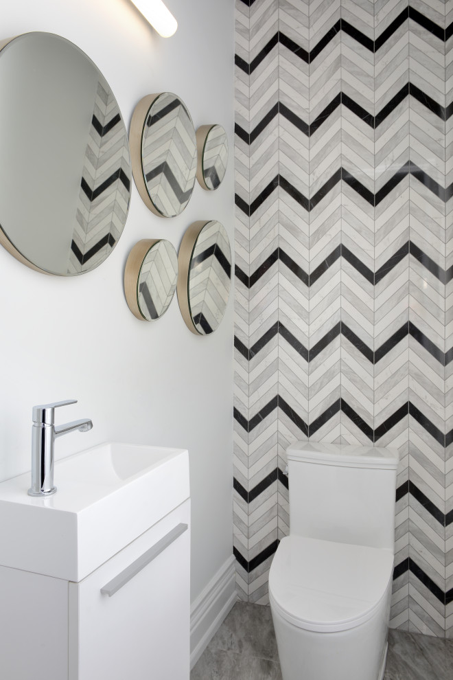Inspiration for a small contemporary powder room in Toronto with flat-panel cabinets, white cabinets, a one-piece toilet, black and white tile, mosaic tile, grey floor and a freestanding vanity.