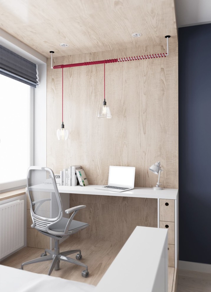 Photo of a small scandinavian study room in Other with beige walls, light hardwood floors and a built-in desk.