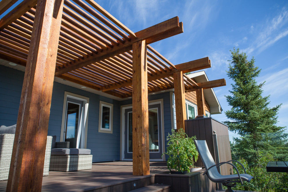 Inspiration for a mid-sized contemporary backyard deck remodel in Calgary with a pergola