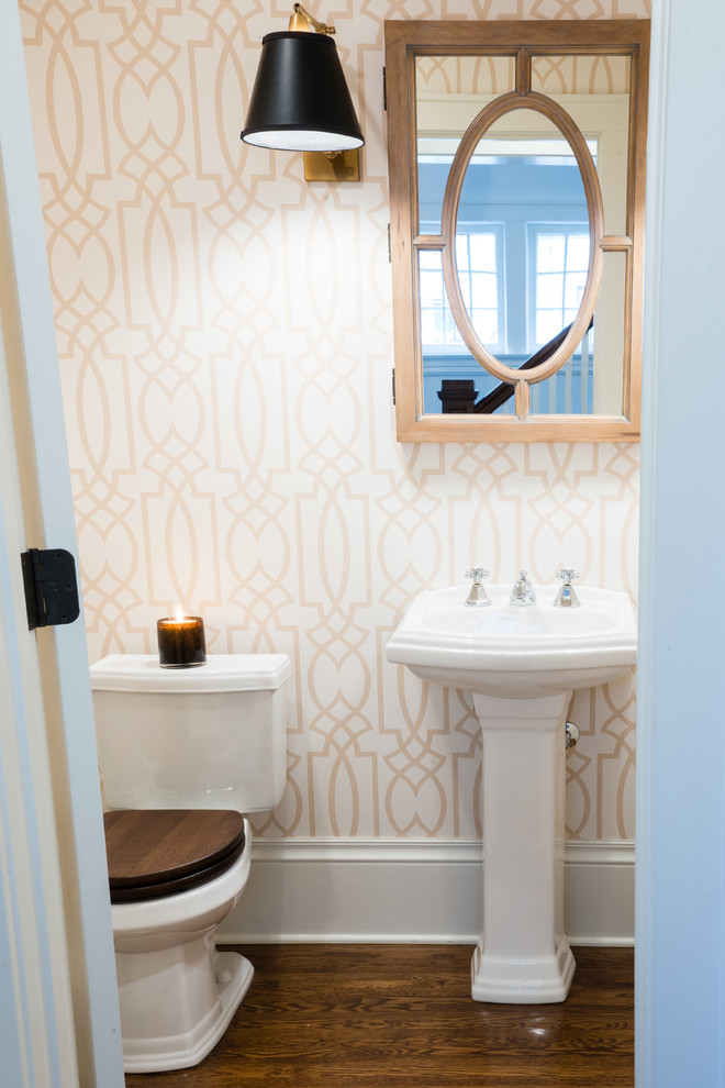 Small transitional powder room in Chicago with a pedestal sink, light wood cabinets and a two-piece toilet.