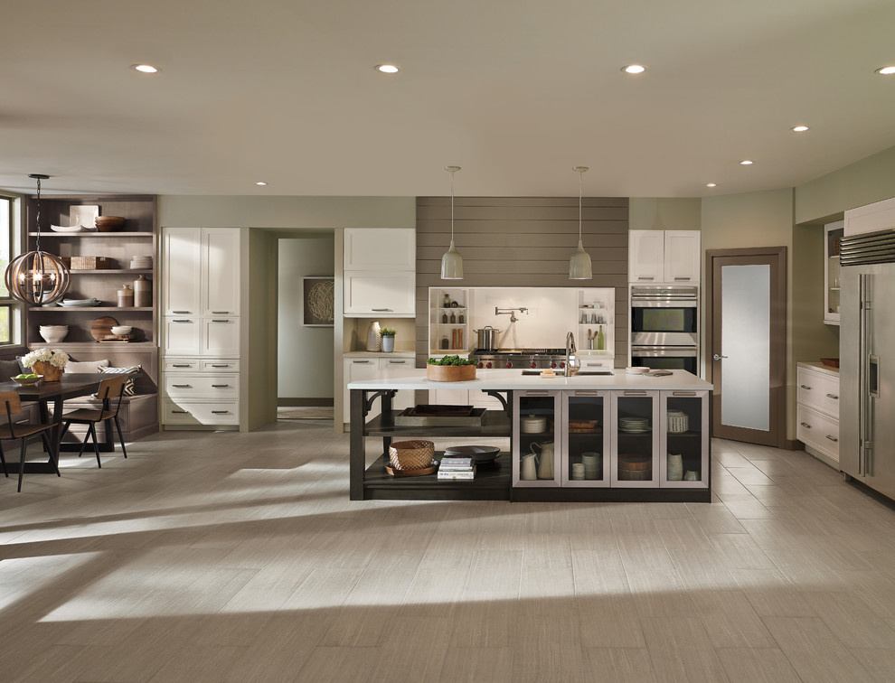 Open concept kitchen - large transitional l-shaped porcelain tile open concept kitchen idea in Toronto with an undermount sink, shaker cabinets, white cabinets, solid surface countertops, white backsplash, stainless steel appliances and an island