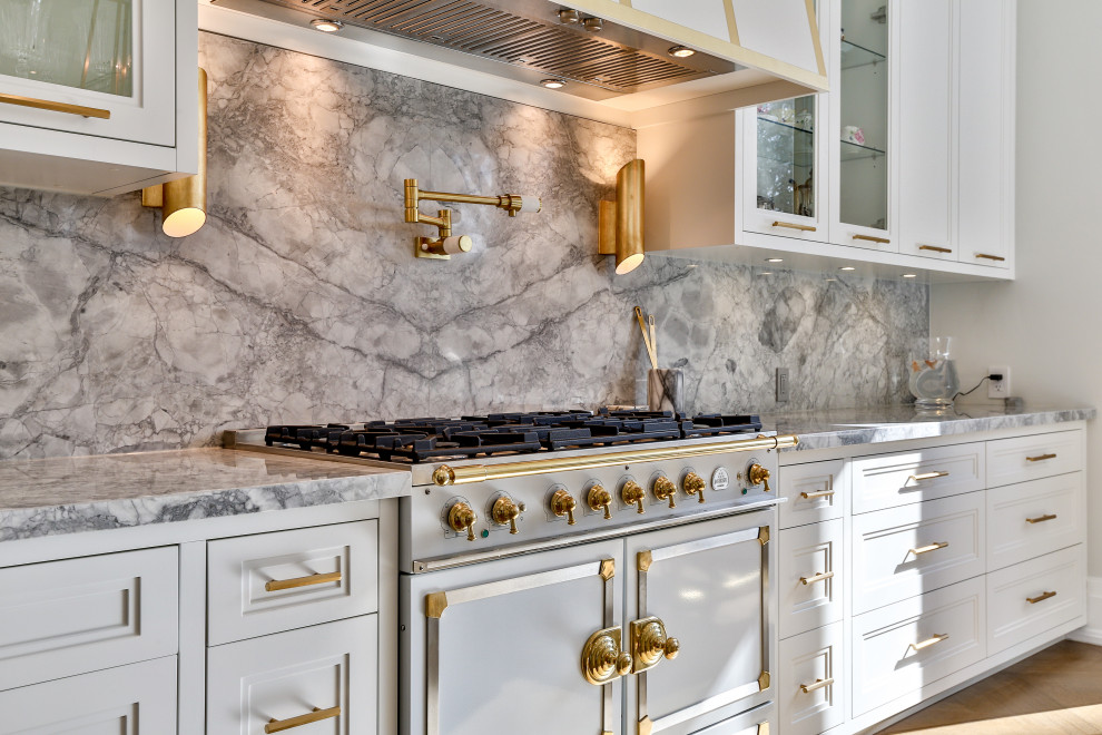 Transitional light wood floor kitchen photo in Toronto with an undermount sink, white cabinets, marble countertops, an island and gray countertops