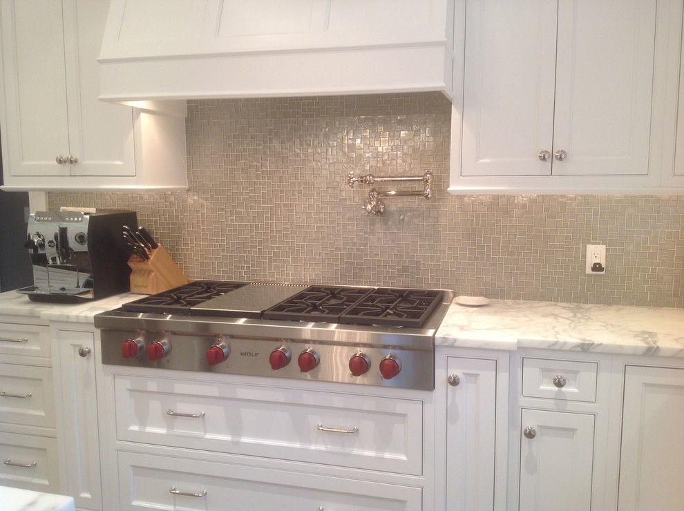 Transitional kitchen photo in New York with gray backsplash, glass sheet backsplash and stainless steel appliances