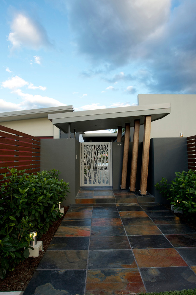 Design ideas for a contemporary beige exterior in Brisbane with mixed siding.