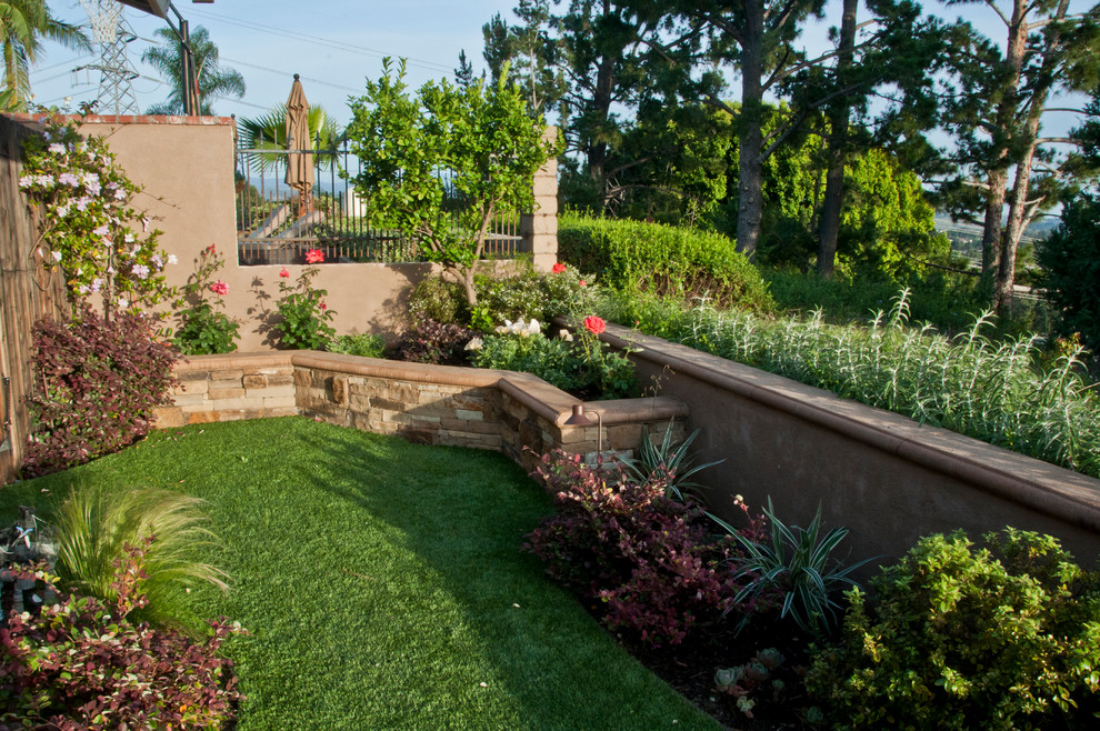 This is an example of a mid-sized rustic landscaping in Orange County.