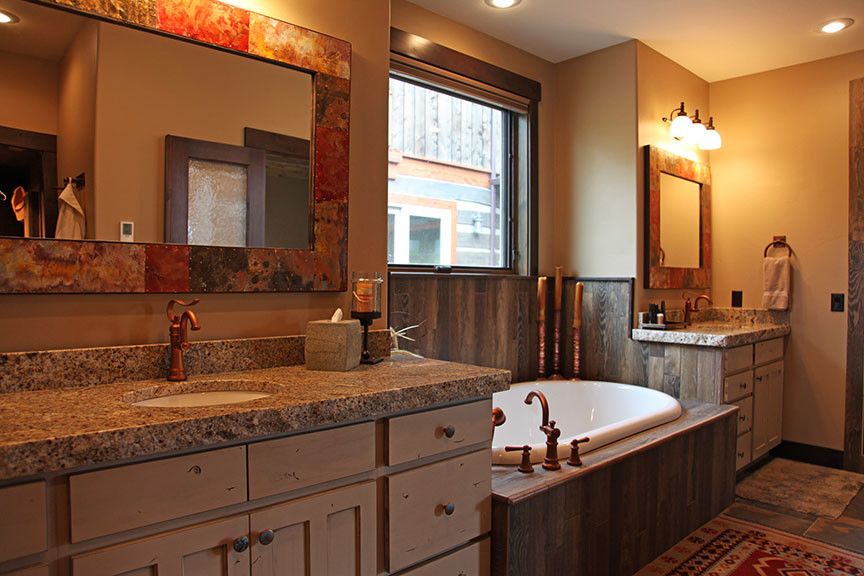 Example of a mountain style bathroom design with granite countertops