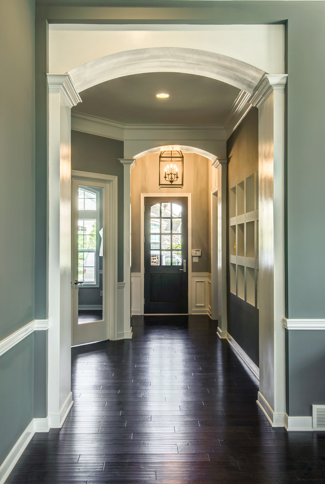 Mid-sized contemporary entry hall in Cleveland with grey walls, dark hardwood floors, a single front door and a black front door.