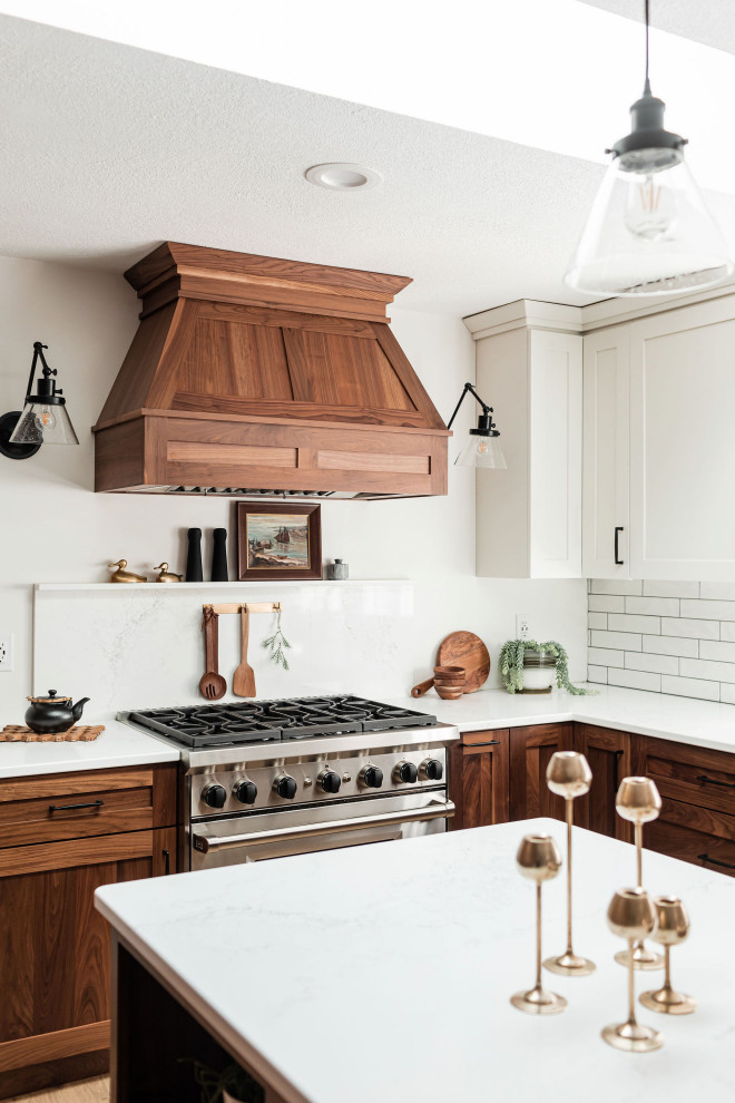 Inspiration for a large scandi kitchen/diner in Minneapolis with shaker cabinets, dark wood cabinets, marble worktops, marble splashback, stainless steel appliances, light hardwood flooring, an island and white worktops.