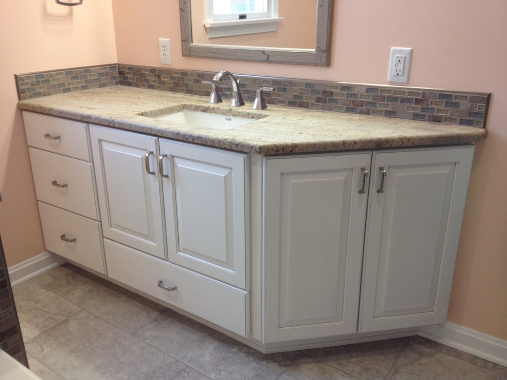 Inspiration for a mid-sized transitional kids' gray tile and porcelain tile porcelain tile alcove bathtub remodel with an undermount sink, raised-panel cabinets, white cabinets, granite countertops and orange walls