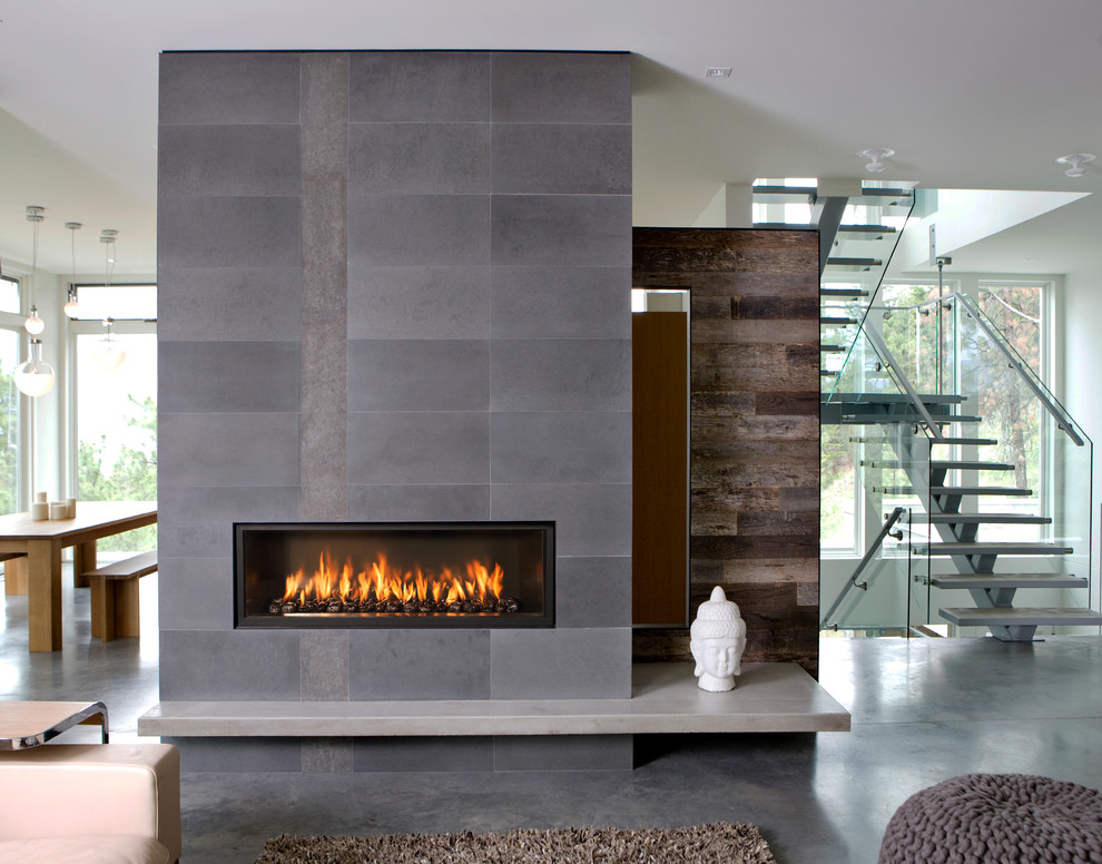 Design ideas for a contemporary open concept living room in Sacramento with concrete floors and a ribbon fireplace.