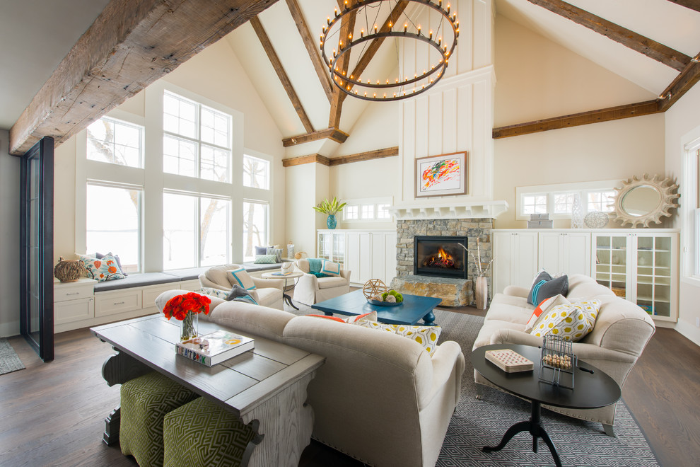 This is an example of a beach style formal open concept living room in Other with beige walls, dark hardwood floors, a standard fireplace, a stone fireplace surround and brown floor.