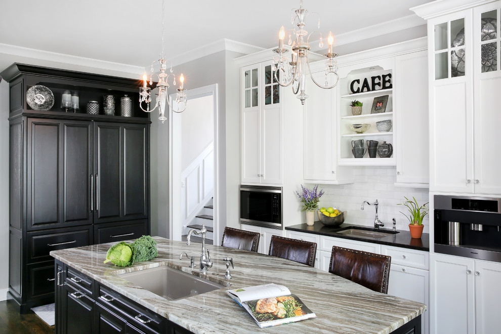 Design ideas for a large traditional u-shaped eat-in kitchen in Chicago with an undermount sink, raised-panel cabinets, white cabinets, quartz benchtops, white splashback, subway tile splashback, stainless steel appliances, dark hardwood floors and with island.