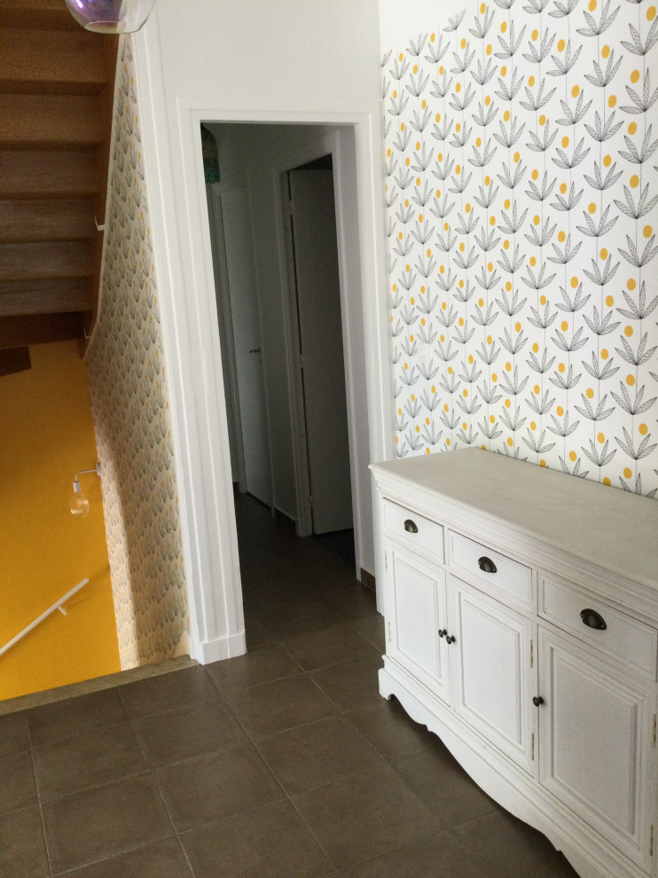 Inspiration for a modern ceramic tile, brown floor and wallpaper hallway remodel in Other with yellow walls