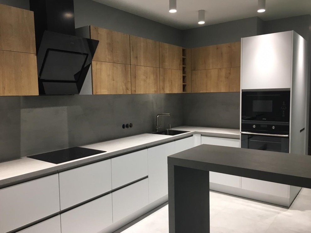 Inspiration for a mid-sized contemporary l-shaped separate kitchen in Other with a single-bowl sink, flat-panel cabinets, white cabinets, laminate benchtops, grey splashback, stainless steel appliances, porcelain floors, no island, grey floor and grey benchtop.