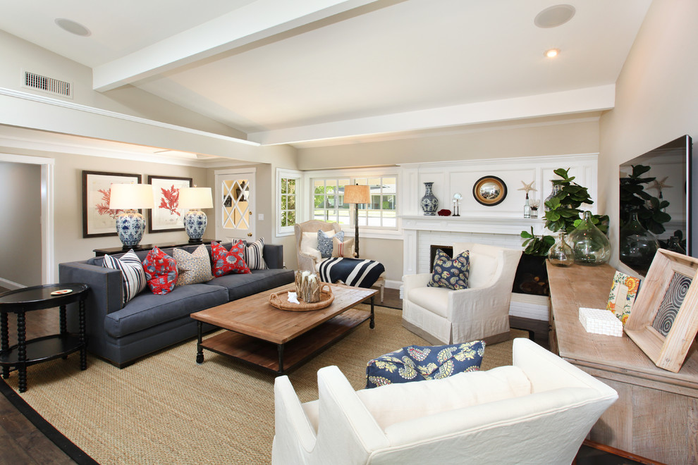 Beach style living room in Orange County with beige walls and a wall-mounted tv.